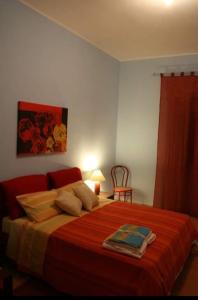 a bedroom with a large bed with a red blanket at Gemma del salento in Sternatia