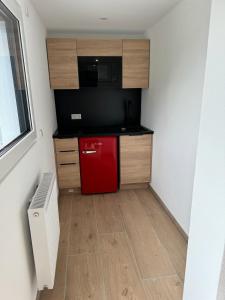 a small kitchen with a red refrigerator in a room at B&S Aparthotel in Weißenhorn