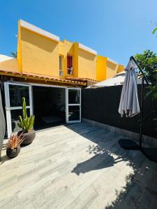 a patio with an umbrella in front of a house at Bungalow Casita in Maspalomas +14 photos