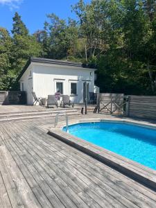 a swimming pool on a deck next to a building at Pool House in Tyresö