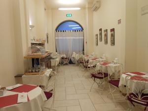 a room with tables and chairs and a window at Hotel Atlantic in Bologna