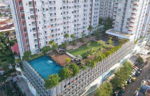 an aerial view of a large building with a pool at Scenic Studio Room Apartment Vida View Makassar By Travelio in Pampang