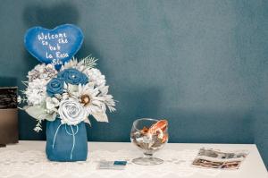 a blue vase with flowers on a table at La Rosa Blu in Gerace