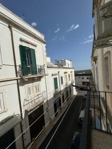 a view of a street with two buildings and cars at Nonna Gio' in Martina Franca