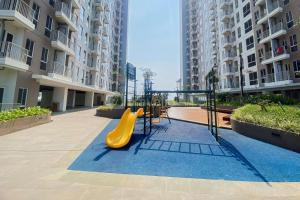a playground with a slide in the middle of a building at Homey and Good Choice Studio Tokyo Riverside PIK 2 Apartment By Travelio in Rawalembang