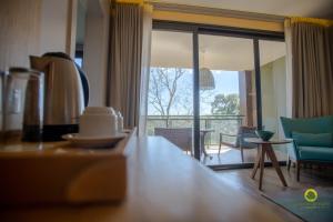 a living room with a view of a living room at Iguazu Jungle Lodge in Puerto Iguazú