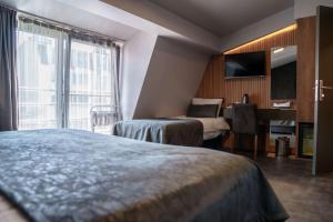 Cama ou camas em um quarto em SennaCity Hotel