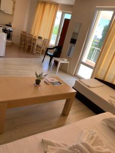 a living room with a couch and a table at MNG Holiday Yassen Apartments in Sunny Beach +53 photos