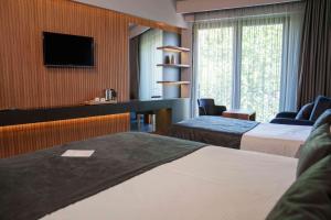 Cama ou camas em um quarto em SennaCity Hotel
