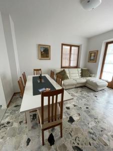 a living room with a table and chairs and a couch at Casa Valentina in Ledro +6 photos