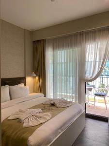a bed in a hotel room with a window at KUCA URLA in Urla