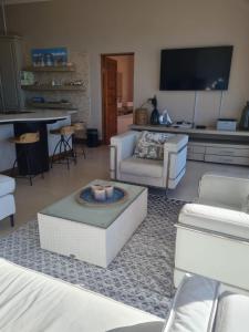 a living room with a couch and a table at Point Village Accommodation - Santos 61/62 in Mossel Bay