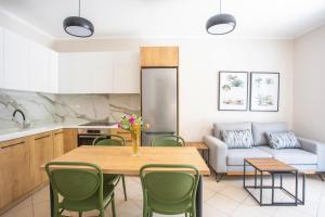 a kitchen and living room with a table and chairs at Melissa Zoe House in Vasiliki
