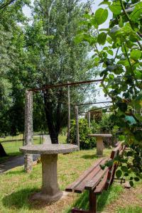 a picnic table and bench in a park at Casa das Fontes in Ponte da Barca +37 photos