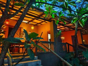 a house with a porch with trees and a patio at Dar Amane Guest House in Graskop