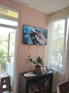 a living room with a tv hanging on the wall at E L A in K'obulet'i
