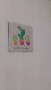a picture of cactuses in pots on a wall at Caminhos do Mar Hostel in Porto De Galinhas