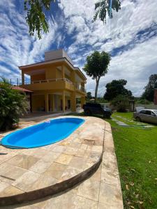 a villa with a swimming pool in front of a house at Casa Amarilla Alter in Alter do Chao