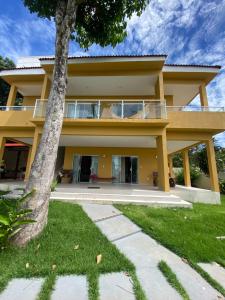 a yellow house with a tree in front of it at Casa Amarilla Alter in Alter do Chao