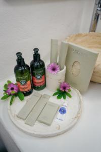 two bottles of soap and flowers on a table at Kassandra Boutique Hotel in Oludeniz