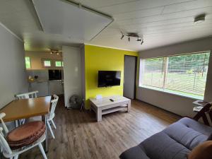 a living room with a couch and a table at Ferienhaus AUEN mit Seezugang in Velden am Wörthersee