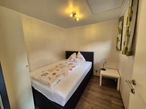 a small room with a bed and a table at Ferienhaus AUEN mit Seezugang in Velden am Wörthersee