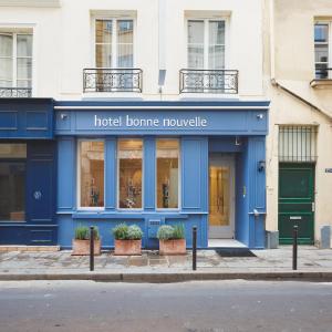 a hotel bonne rouge on a city street at Hôtel Bonne Nouvelle in Paris