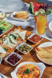 a table topped with plates of food and drinks at Kassandra Boutique Hotel in Oludeniz