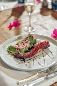 a plate of food on a table with a salad at Kassandra Boutique Hotel in Oludeniz