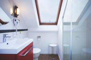 a bathroom with a sink and a toilet and a window at Hôtel Bonne Nouvelle in Paris