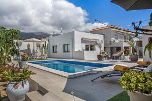 una casa con piscina en un patio en Piscina Climatizada, en La Hidalga