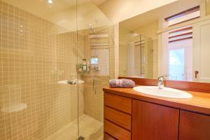 a bathroom with a sink and a glass shower at Sa Calma in Llafranc +19 photos