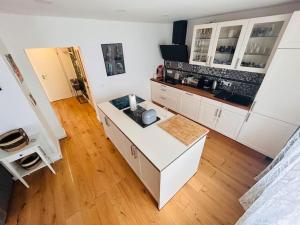 a kitchen with white cabinets and a counter top at Schöne EG-Wohnung Heiligenhaus in Heiligenhaus
