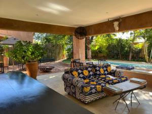 a living room with a couch and a table at Tabokana House in Victoria Falls