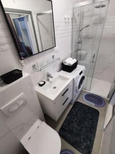 a bathroom with a toilet and a sink and a shower at Apartment Beba in Kaštela +26 photos