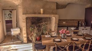 a dining room with a table and a fireplace at Maison Melrose in Vouvray +26 photos