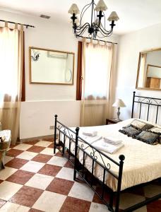 a bedroom with a bed and a checkered floor at Venice Secret Garden view in Venice