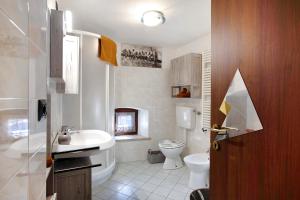 a bathroom with a toilet and a sink at Maison Bebe Terre Blanche in Aosta +14 photos