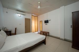 Postel nebo postele na pokoji v ubytování Hotel Oviya
