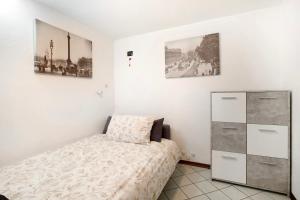 a bedroom with a bed and a dresser at Maison Bebe Terre Blanche in Aosta
