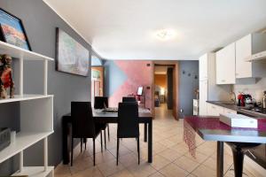 a kitchen and dining room with a table and chairs at Maison Bebe Terre Blanche in Aosta