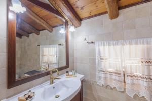 a bathroom with a sink and a mirror at Villa Oros in StrinÃ½las +44 photos