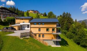 a house on a hill with a garage at Panorama Lodge Premium Apartments in Schladming