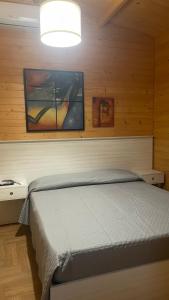 a bedroom with a bed in a wooden wall at Cocus in Ravanusa +46 photos