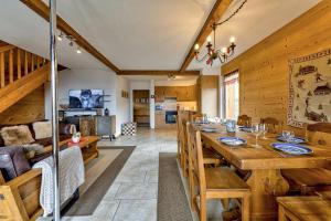 a dining room with a large wooden table and chairs at Chalet le Raccard in La Tzoumaz