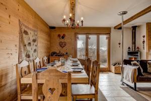 a dining room with a wooden table and chairs at Chalet le Raccard in La Tzoumaz