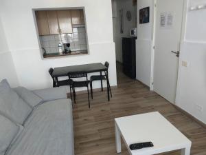 a living room with a couch and a table at Vista Puerto Ground Floor No Balcon in Arguineguín