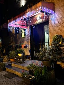 a brick building with plants and lights on it at Elle Boutique Hotel in Tbilisi City