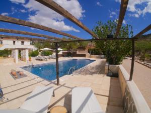 a swimming pool in a villa with a house at B&B Boutique Casa Clavi in Chirivel