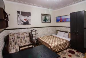 a bedroom with a bed and a chair in it at Bonus in Vinnytsya